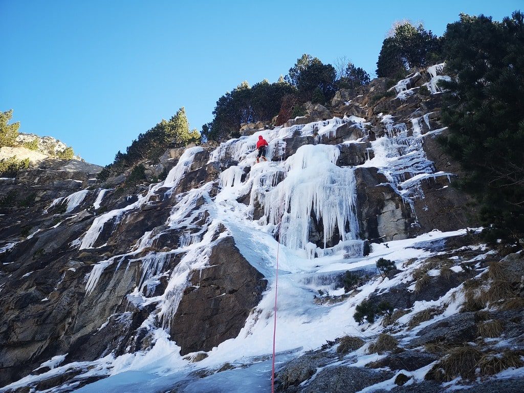 Escaladores en la parte superior de la cascada de hielo en los Pirineos