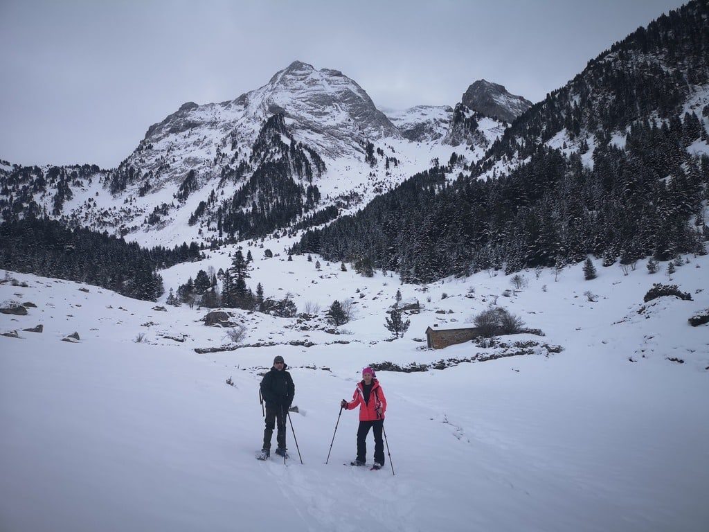 una pareja haciendo un paseo por la boca norte del tunel de vielle con paisaje nevado